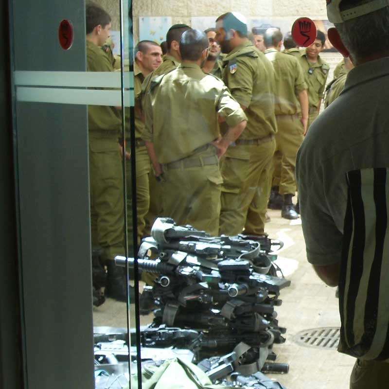 Guns at Yad Vashem: Young Israelis visit Yad Vashem, Israel's national Holocaust memorial, to complete their induction in the Israeli Army. They deposit their weapons at the entrance.  Image © Mike Joseph.